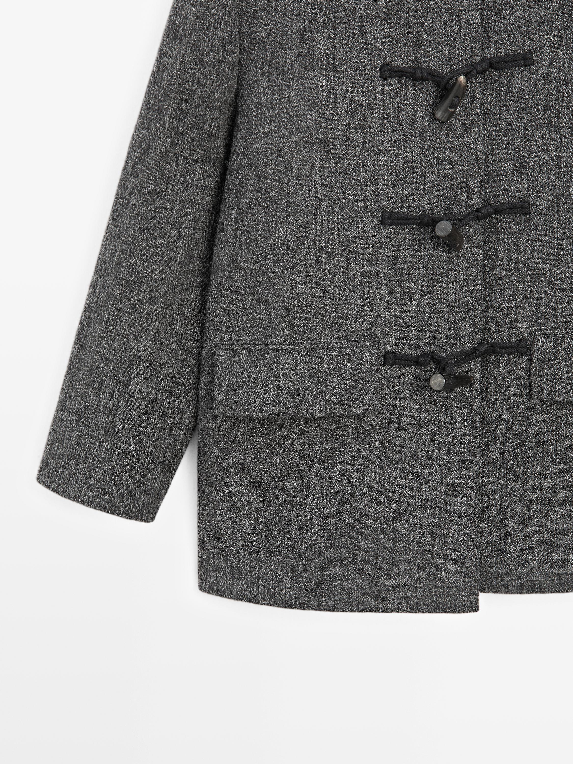 Mid-length coat with horn toggle
